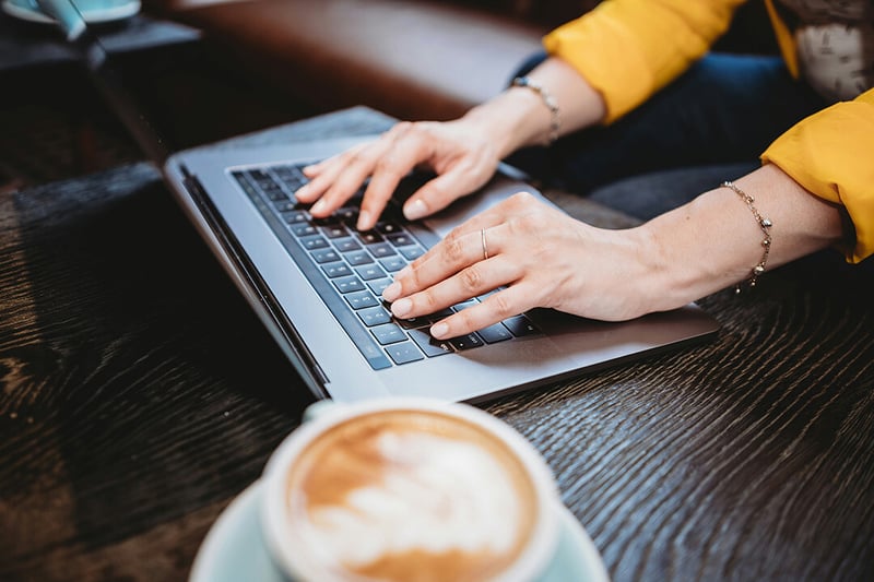 Person typing on keyboard searching for talent assessment provider