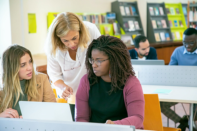 Hiring manager and candidate at computer calculating score
