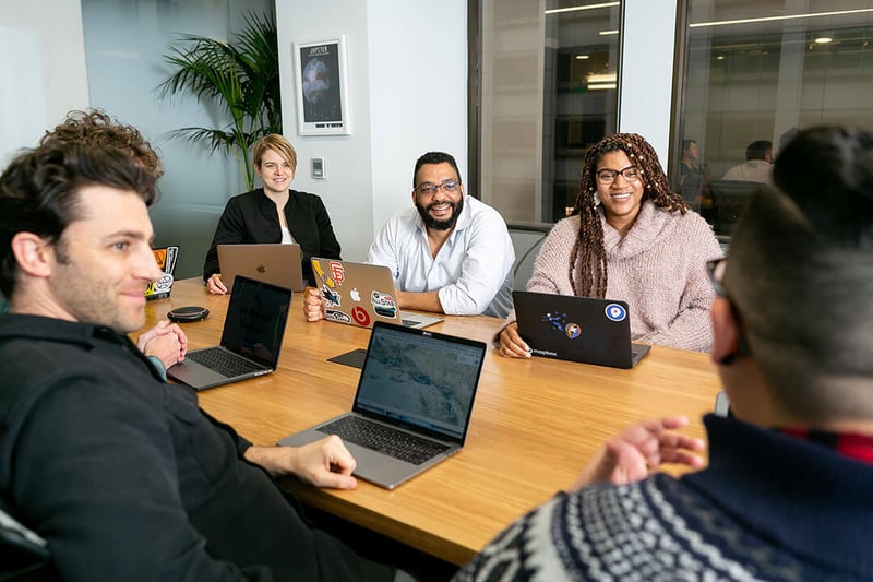 Powerful people sitting around meeting table